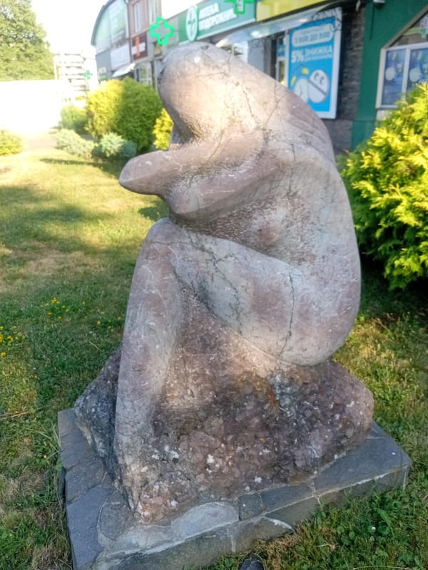 Public square in Tiachiv with fountain and stone sculptures