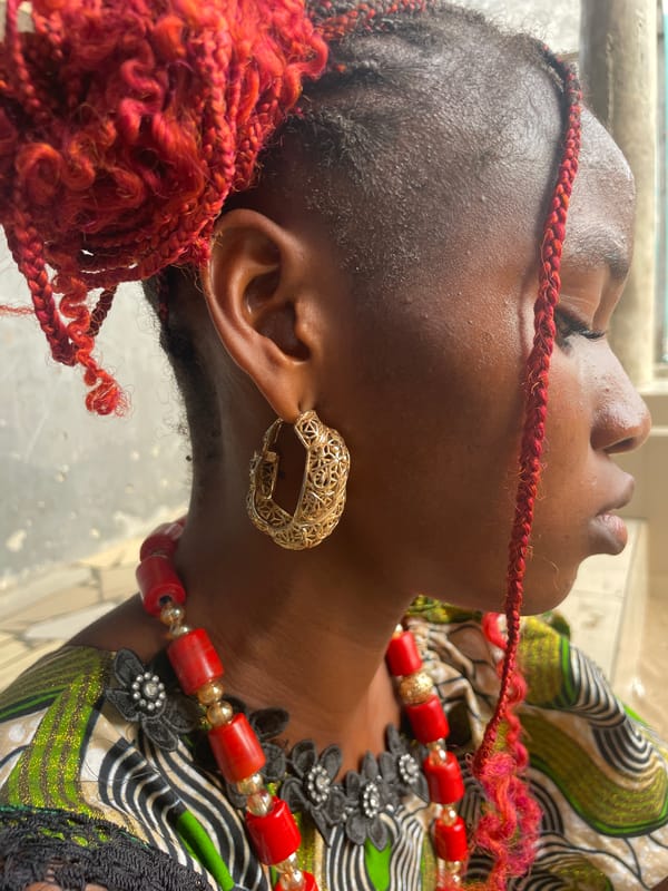 Person with red braided hair photographed in Badagry, Nigeria