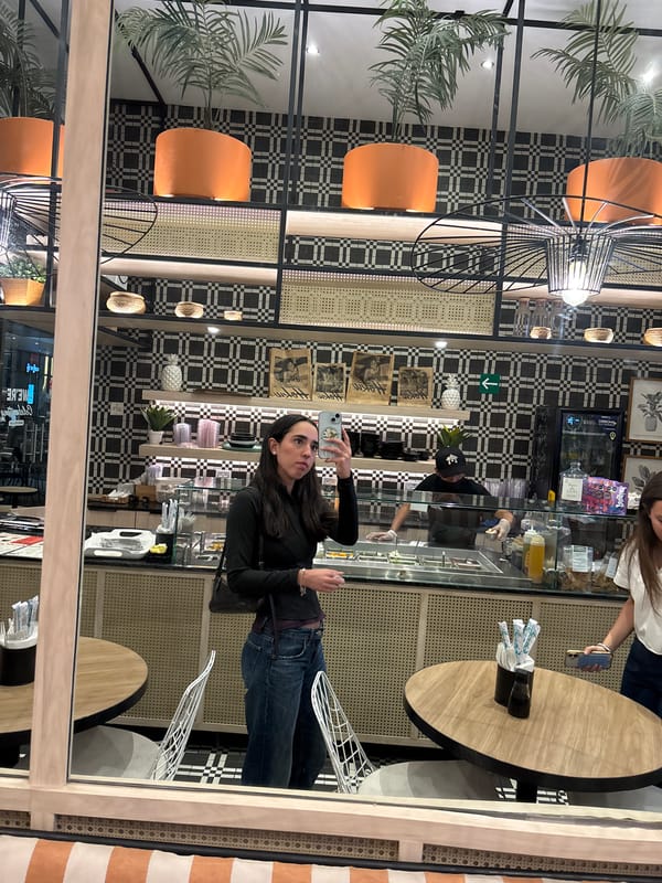 Restaurant customer photos display while worker prepares food