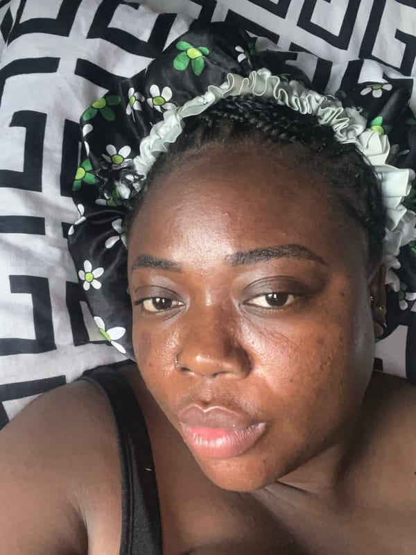 Woman takes multiple selfies wearing floral bonnet in Abuja
