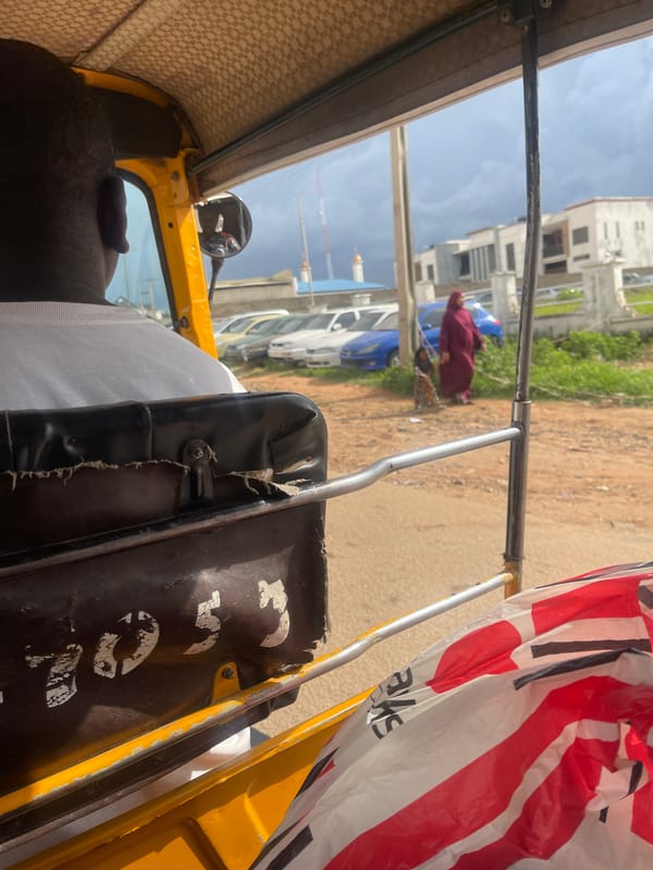 Street traffic and roadside commerce on a Jos, Nigeria thoroughfare