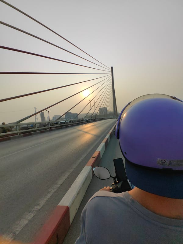 Motorcyclist crosses Bai Chay Bridge overlooking Ha Long Bay