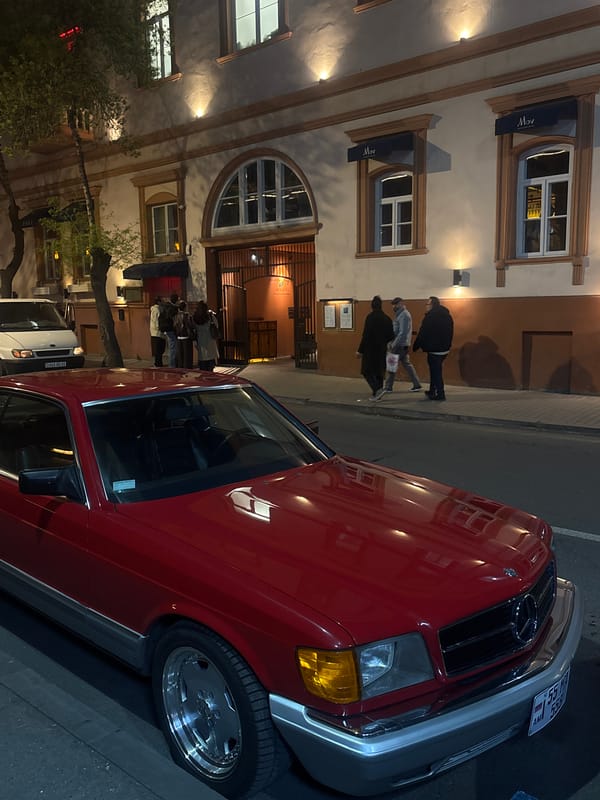 Red Mercedes parked on busy Yerevan street draws attention
