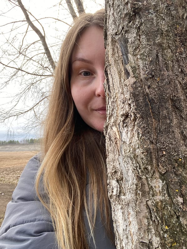 Jack Russell Terrier climbs moss-covered tree in Russia