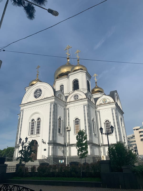 Orthodox church complex with golden domes and bronze statues documented