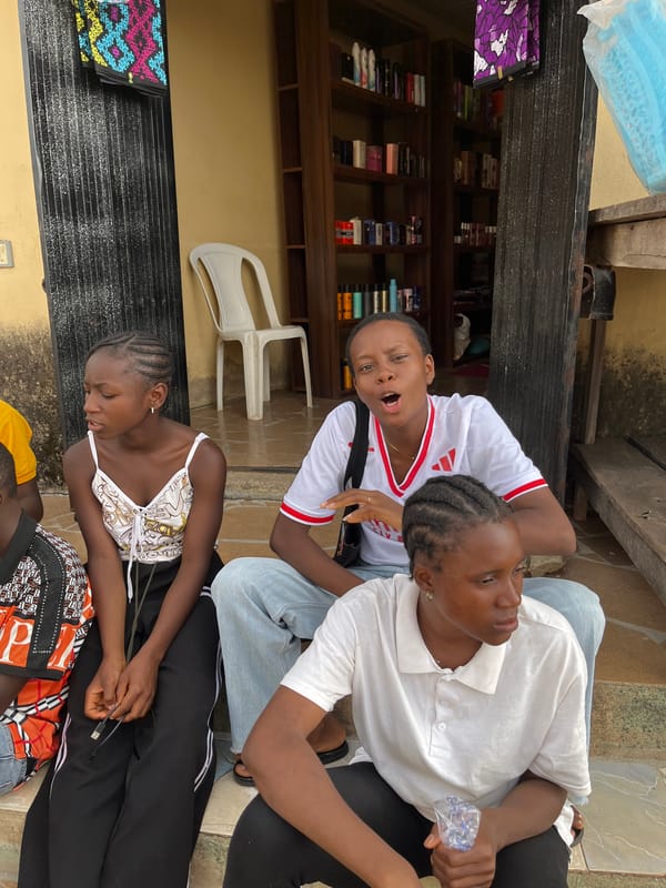 Young people gather casually outside shop in Jos, Nigeria