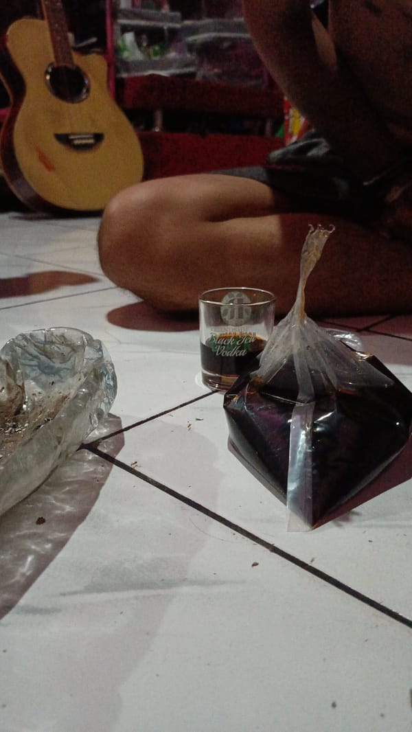 Young men vaping, relaxing indoors in Depok residence