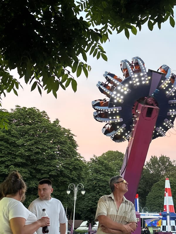 Ferris wheel glows at dusk in Homyel amusement park