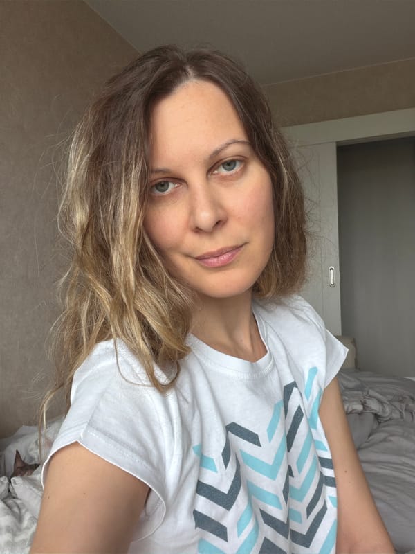 Woman in geometric T-shirt observed resting at unidentified location