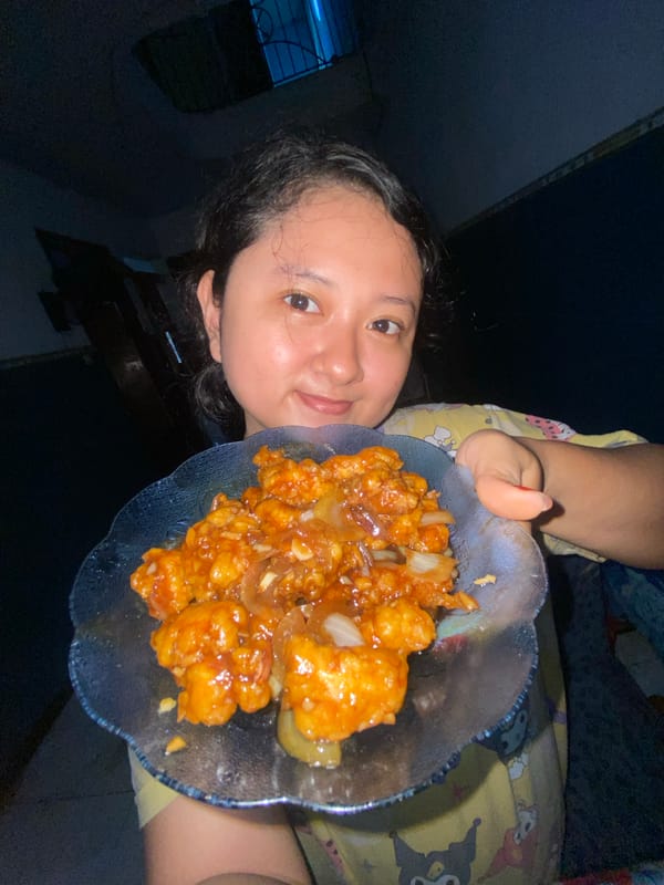 Mother cooks and feeds homemade meal to child in Indonesia