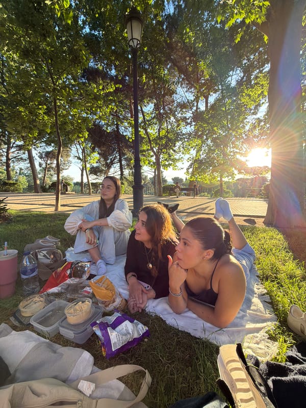 Three women enjoy afternoon picnic in Madrid park