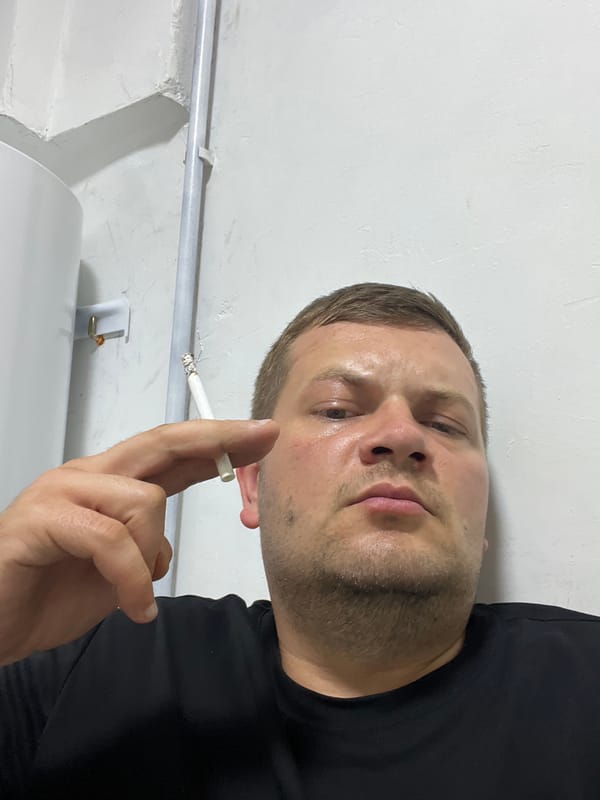 Lit cigarette held close-up in Baku