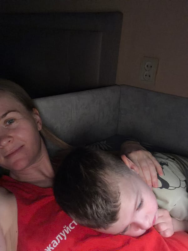 Mother, child share bedtime story in rainy Khabarovsk night