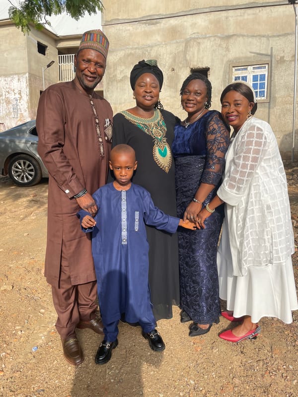 Women and boy pose for photos in Akwanga, Nigeria
