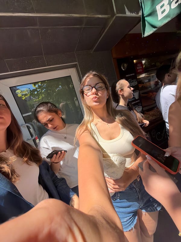 Young women take selfies outside Burgas shops morning