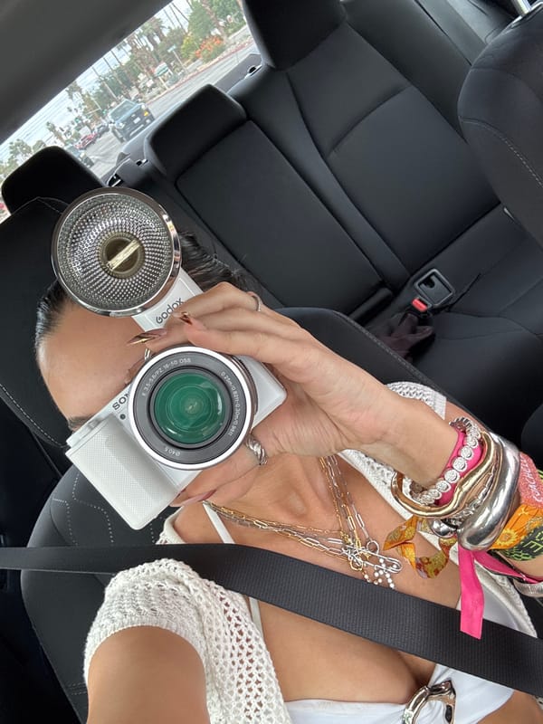 Photographer with camera equipment captured inside car in Palm Springs