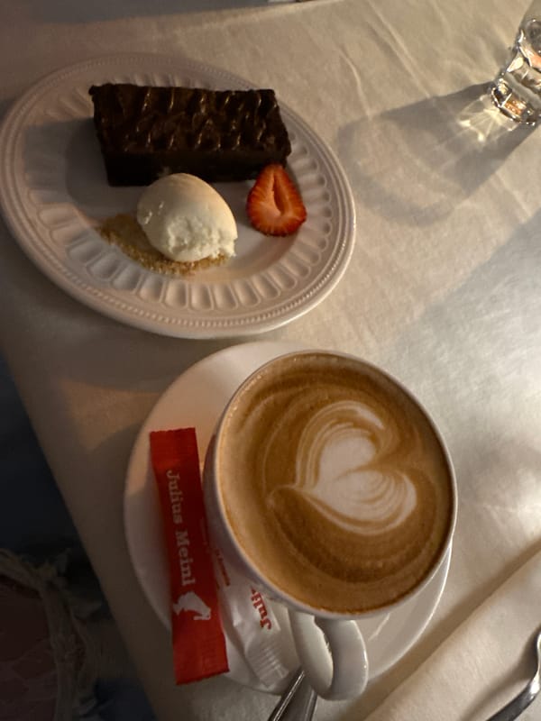 Urban afternoon: cafe dessert, mural building, street performer entertainment