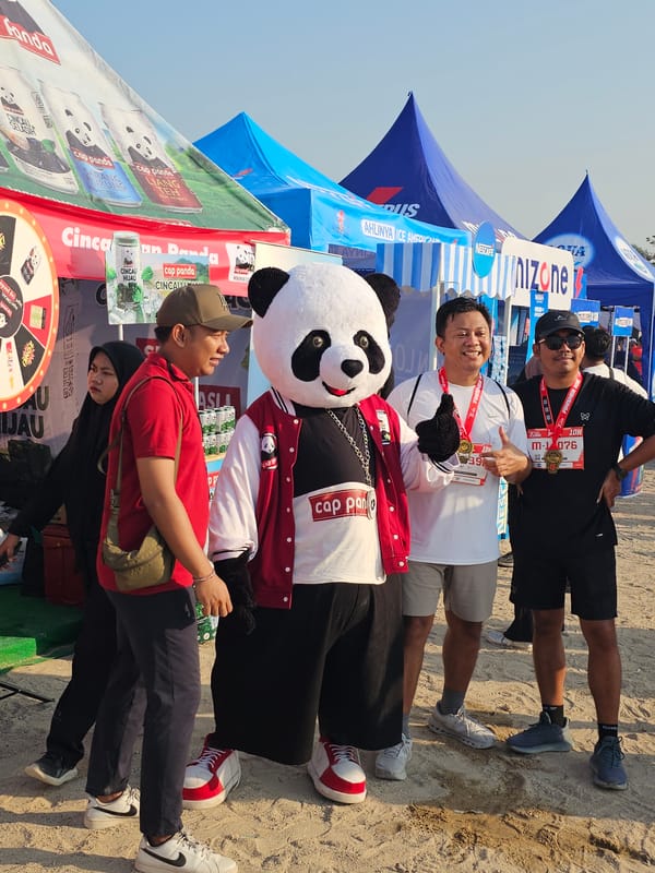 Post-race gathering in Denpasar with BCA branding and a panda mascot