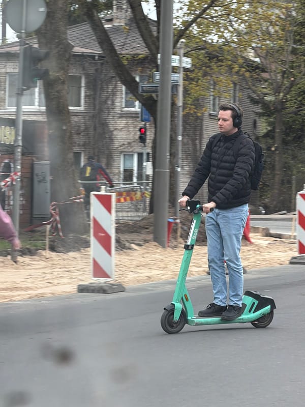 Man rides Bolt scooter past construction zone in Riga