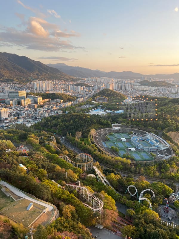 Woman takes selfies overlooking Daegu cityscape from high building