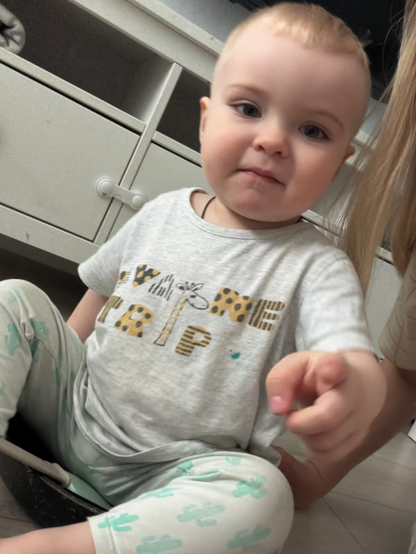 Child plays with green plastic animal toys in Votkinsk