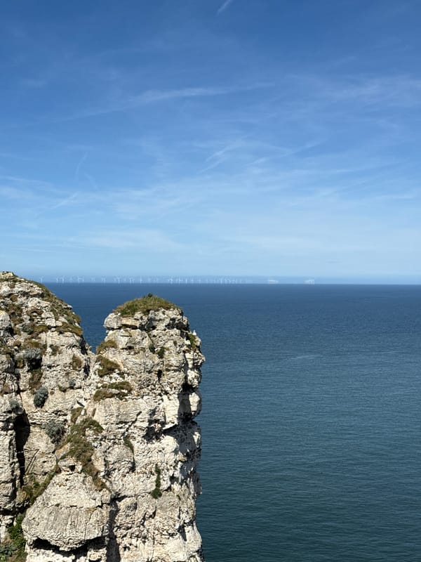 Offshore wind farm photographed from Étretat cliffs, France