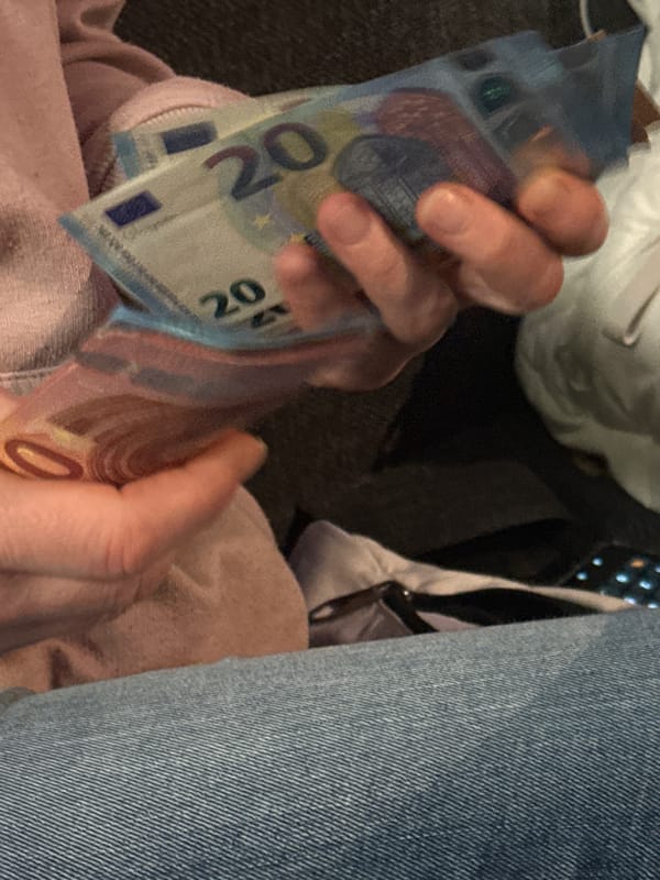 Person holds stack of Euro bills in Varna