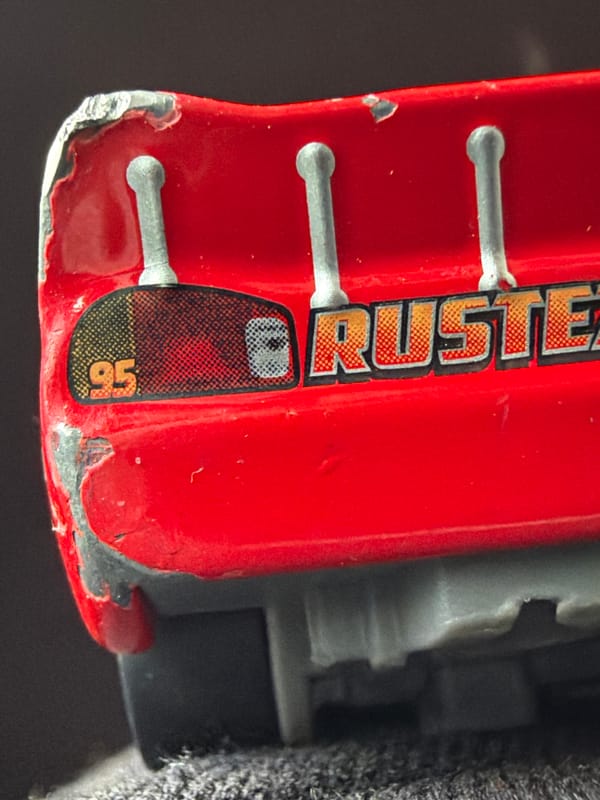 Weathered Lightning McQueen toy photographed in Russian village