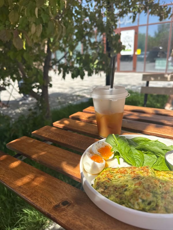 Outdoor meal documented on wooden table in Novosibirsk