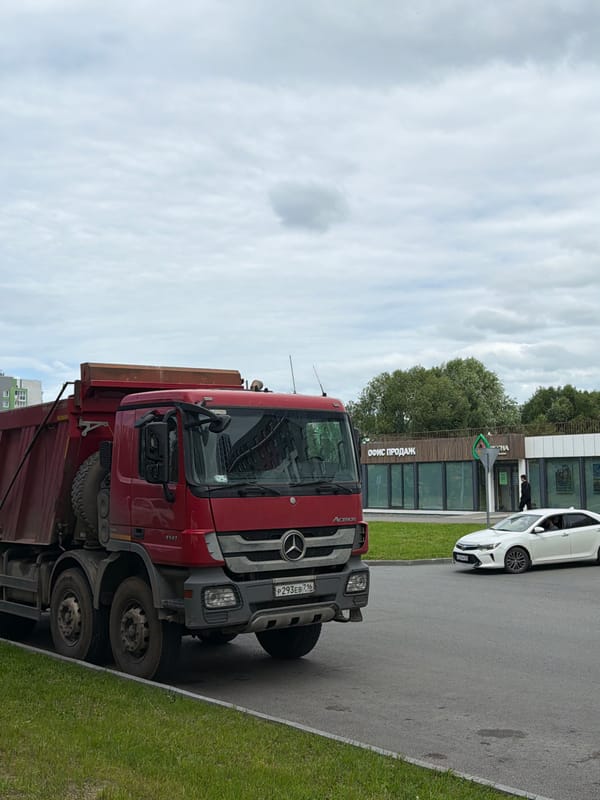 Vehicles, buildings, and street life in a Russian urban area