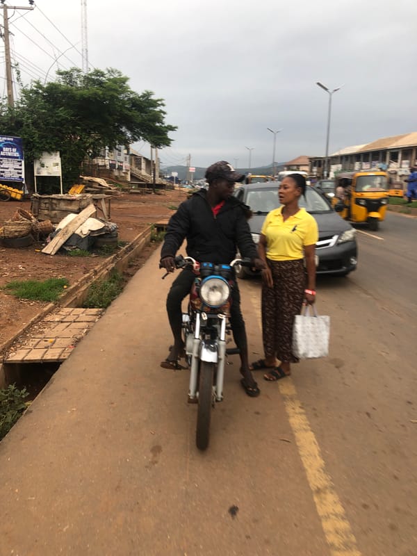 Morning traffic scene observed in Abuja with motorcyclist, pedestrian