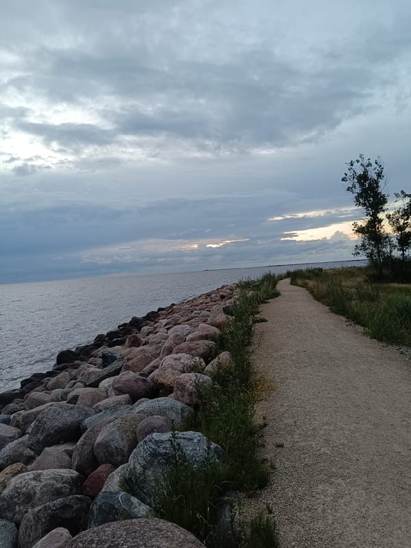 Riga's rocky coastline at dusk under a stormy sky