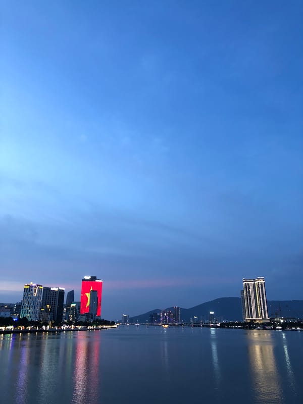 Da Nang's Dragon Bridge lit up along the river at night