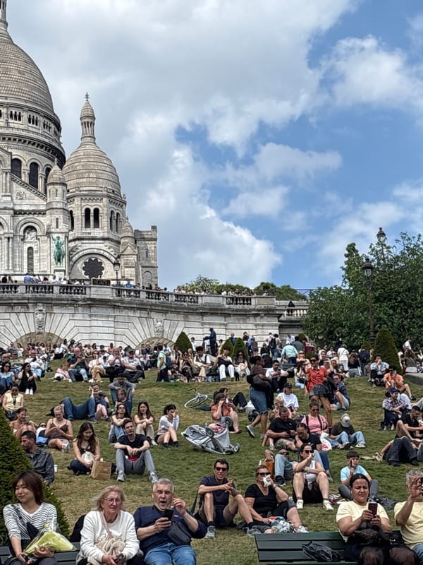 Crowds gather at Sacré-Cœur Basilica on sunny afternoon