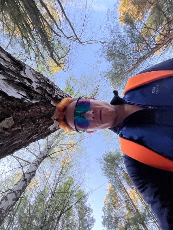 Person in blue jacket photographed in low-angle selfie in Chaikovsky