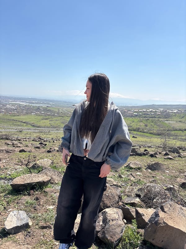 Tourists pose for photos on Byurakan hillside overlooking Armenia