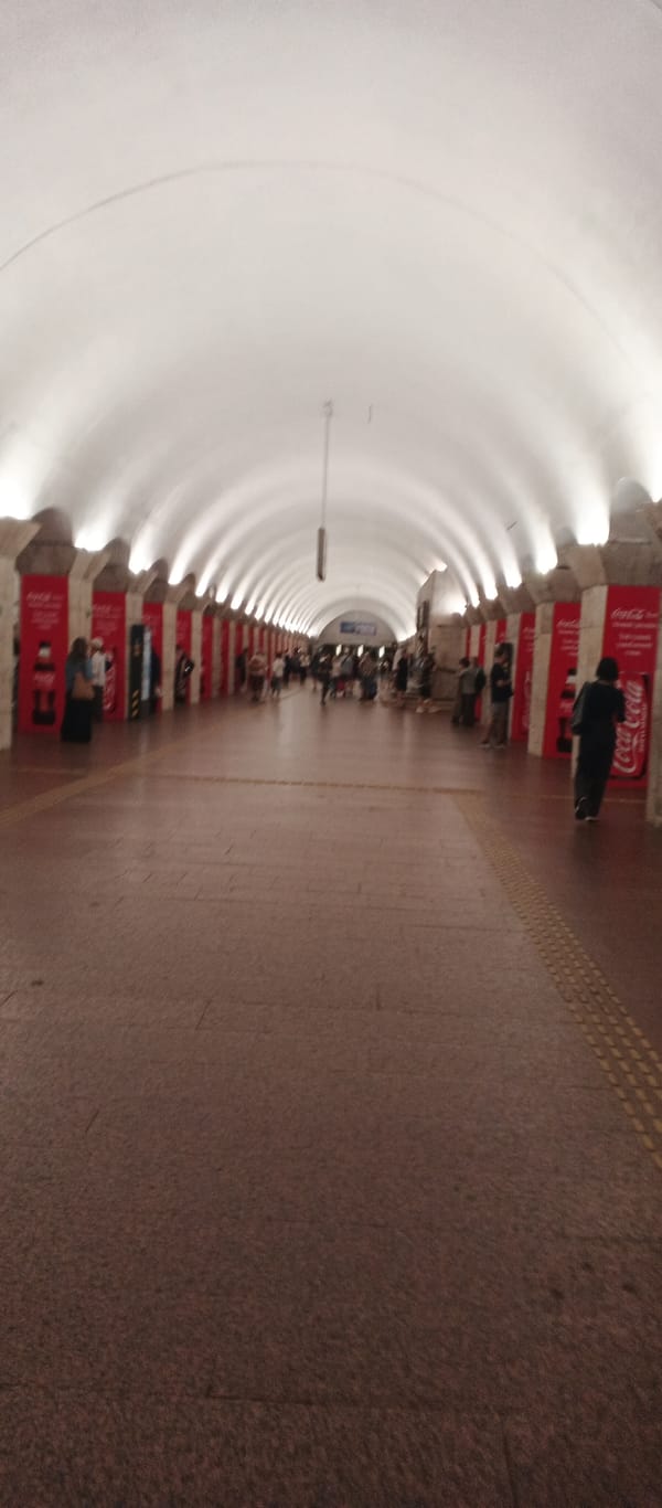Inside a grand Ukrainian metro station with ornate Soviet-era design
