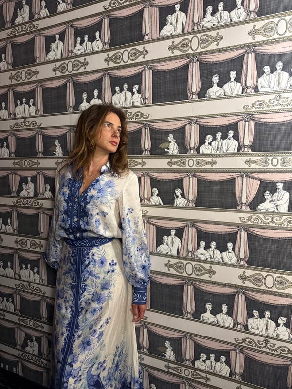 Two women take selfies in patterned room in Vila Verde