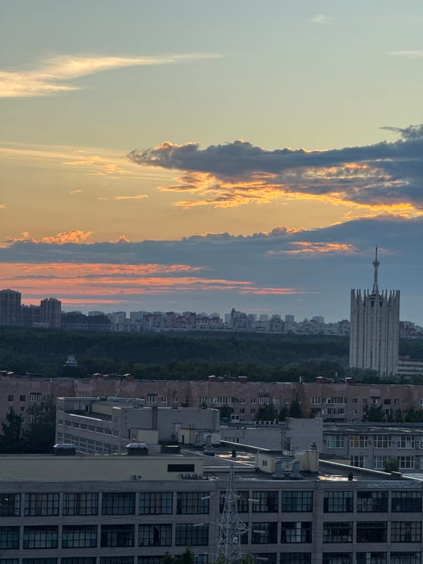 Russian city skyline under a dramatic sunset sky