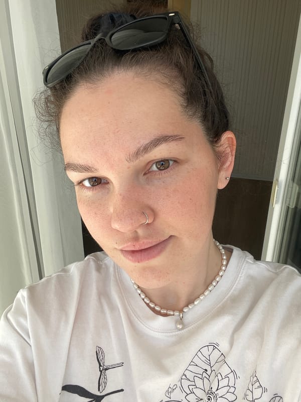 Woman in white t-shirt and pearls photographed Tuesday morning