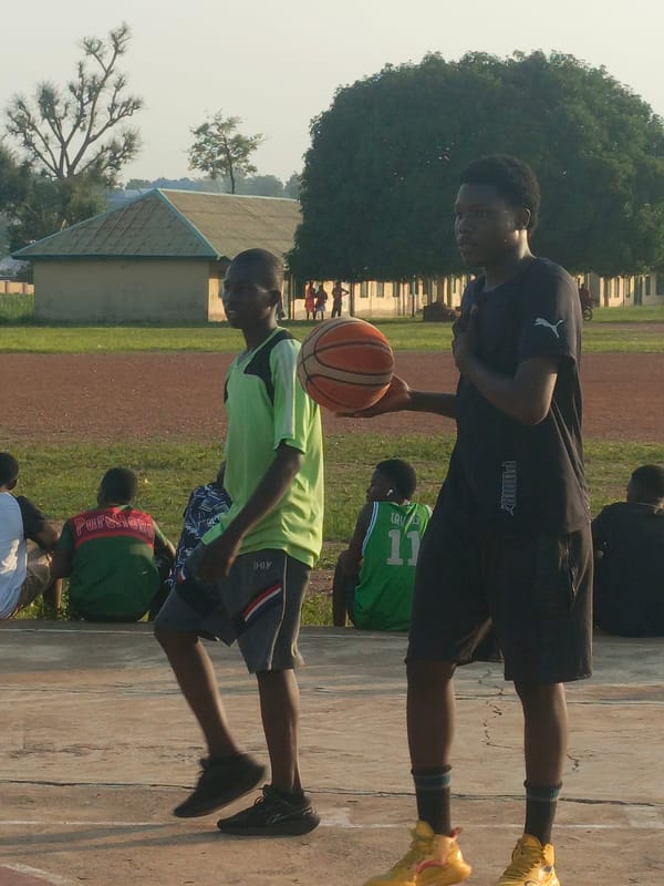 Pickup sports on cracked courts in Akwanga, Nigeria
