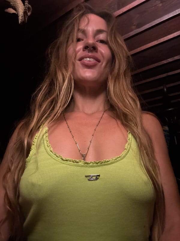 Quick selfie session in a green top, dark background