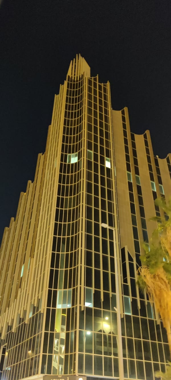 Nighttime drive through illuminated Jeddah commercial districts documented