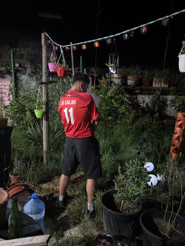 Young men gather for evening soccer viewing in Novi Iskar