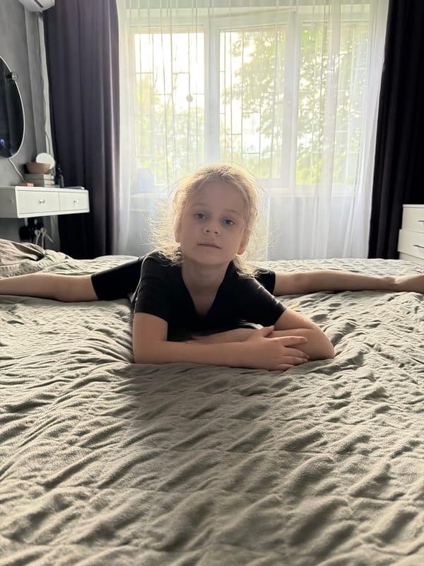 Person performs yoga poses and stretches on bed