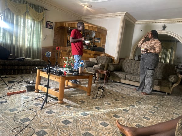 Casual indoor gathering captured during apparent filming in Jos