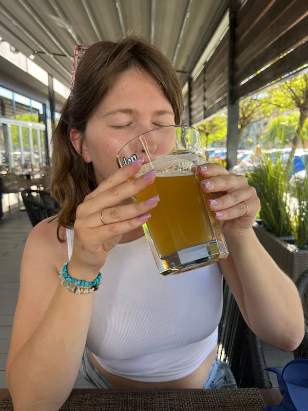 Woman enjoys beer and appetizers in Novi Sad cafe