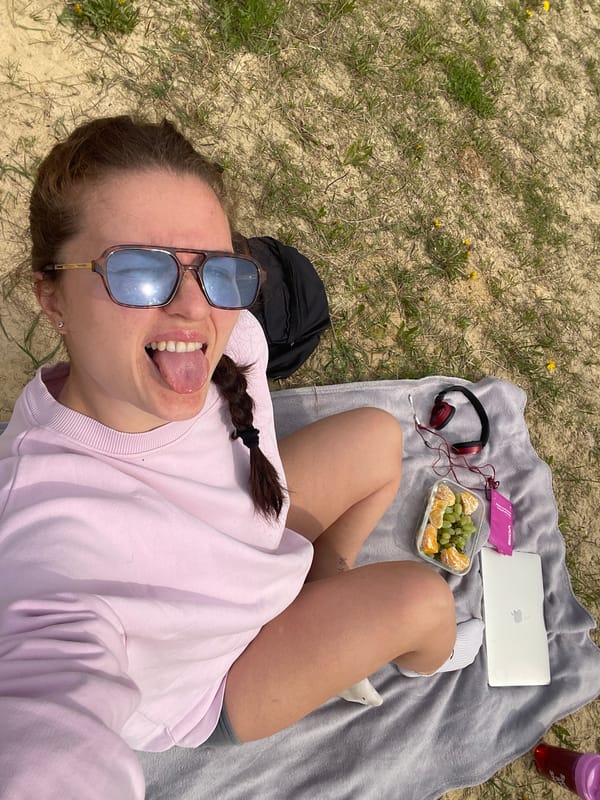 Woman enjoys lakeside picnic with technology in rural Russia