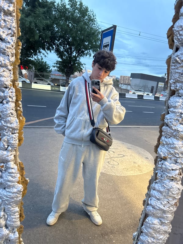 Young man takes mirror selfie at Yerevan bus stop
