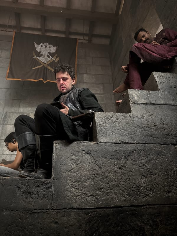 Three people gather at stone structure in Mumbai